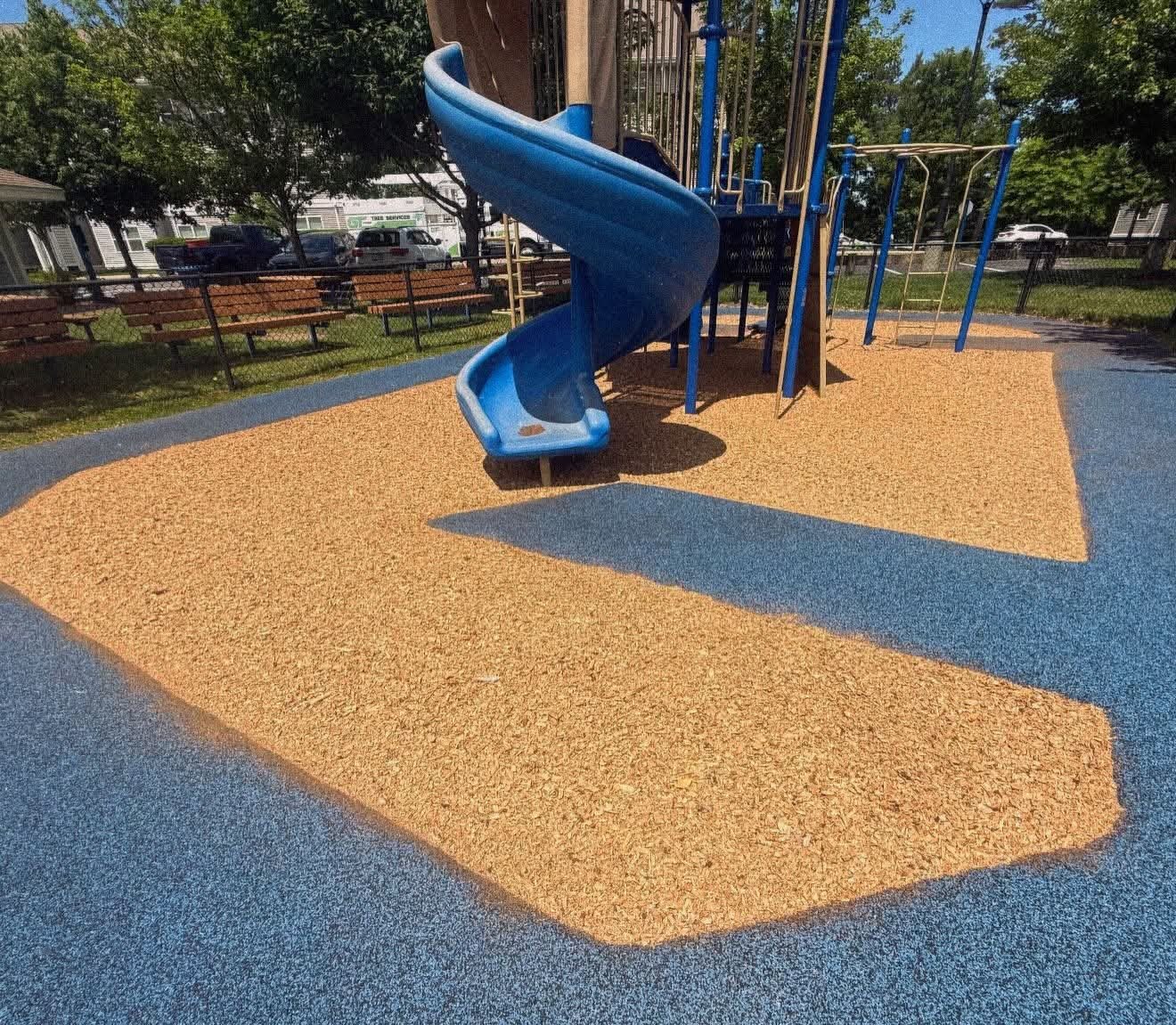 After: fresh, deep playground mulch under the slide