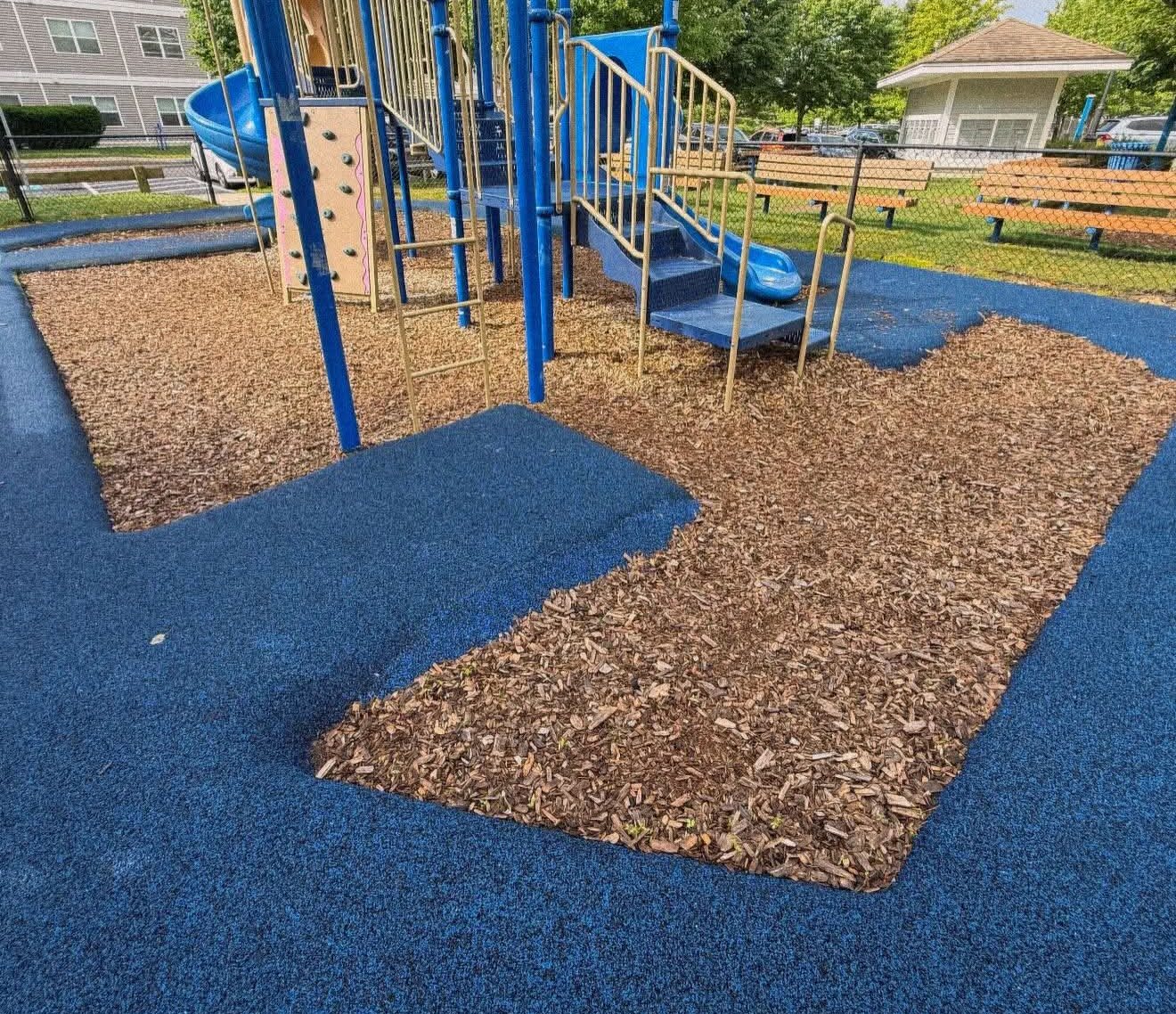 Before: worn, thin wood chips at a community playground
