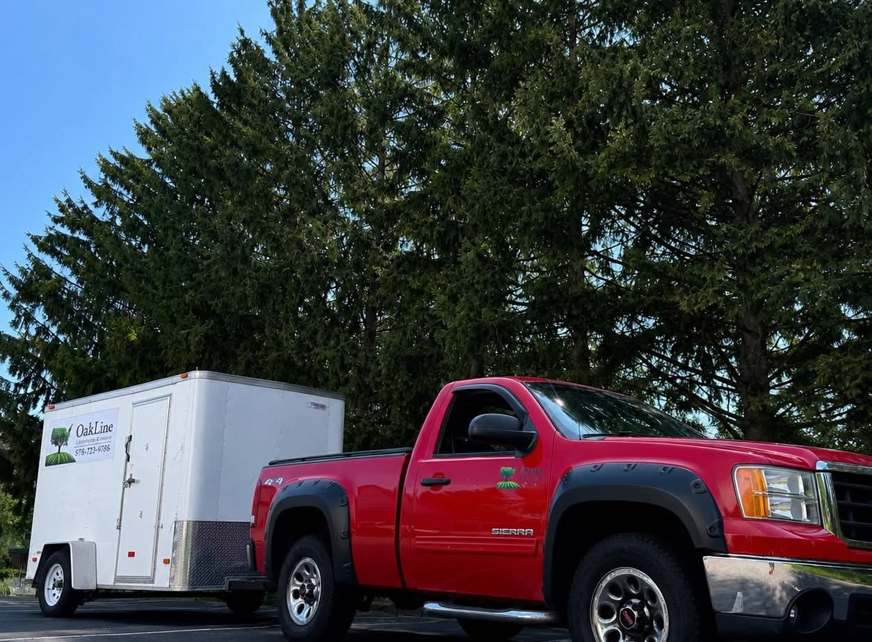 Red GMC pickup and white OakLine trailer